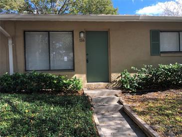 Charming front entrance with a teal door, well-maintained landscaping, and visible house number at 220 Cherokee Ct # 116, Altamonte Springs, FL 32701
