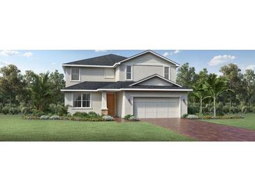 Inviting two-story home featuring a two-car garage, well-manicured lawn, and a mix of modern architectural details at 2577 Fiddle Leaf Loop, Apopka, FL 32712