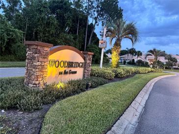 Woodbridge on the Green community sign with stone accents and manicured landscaping at 4251 Willow Bay Dr, Winter Garden, FL 34787