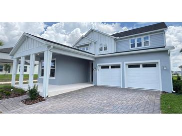 Charming two-story home with a two-car garage and inviting covered entry at 6221 Argent Wood Dr, Winter Garden, FL 34787