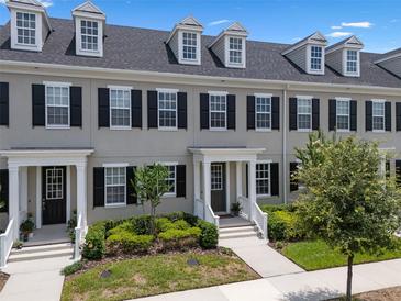 Charming townhome featuring a well-manicured lawn and inviting entrance at 1859 Island Village Way, Kissimmee, FL 34747