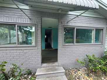Charming front entrance to this brick home featuring a covered entryway and newer windows at 269 12Th Ave, Ocoee, FL 34761