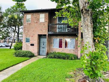 Charming two-story brick home with a balcony and well-maintained front lawn at 5084 Downing St # 2, Orlando, FL 32839