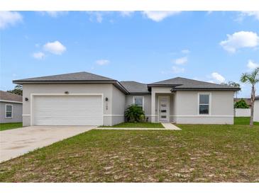 Charming one-story home featuring a two-car garage and well-manicured lawn at 109 Violet Ct, Kissimmee, FL 34759