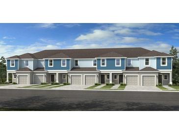 Charming townhome features a gray garage and a blue accent, creating an inviting curb appeal at 2580 Penguin Blvd, Davenport, FL 33837