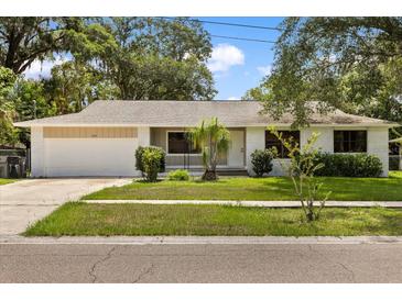 Charming single-story home featuring a well-maintained front yard and attached garage at 575 Lake Mccoy Dr, Apopka, FL 32712