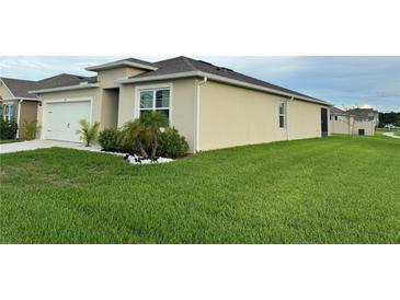 Beautiful single-story home with a two-car garage and well-maintained lawn, perfect for a starter Gathering at 577 Talisi Loop, St Cloud, FL 34771