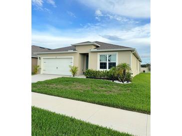 Charming one-story home featuring a two-car garage and beautifully landscaped front yard at 577 Talisi Loop, St Cloud, FL 34771