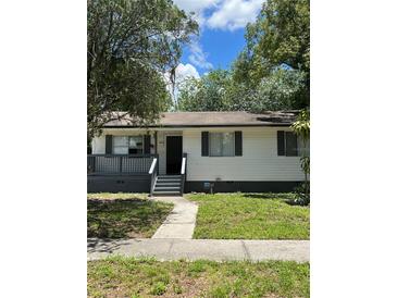 Charming single-story home with a covered porch and well-maintained front yard, creating inviting curb appeal at 2075 Dixie Ave, Sanford, FL 32771