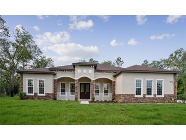 Charming single-story home featuring a welcoming front porch, stone accents, and a well-manicured lawn at 18813 Mosby St, Orlando, FL 32833