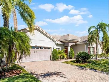 Charming single-story home with paver driveway, mature landscaping, and a two-car garage at 3643 Weatherfield Dr, Kissimmee, FL 34746