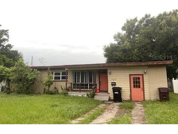 Single story home with lawn, trees, and a two-car driveway leading to the side of the property at 728 Springview Dr, Orlando, FL 32803