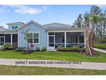 Charming single-story home featuring a screened front porch and well-manicured lawn at 311 Pop Top Ln, Daytona Beach, FL 32124