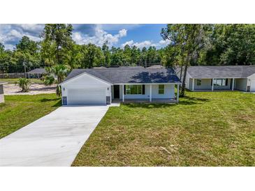 New construction home with gray roof and white siding at 13026 Ne 6 Pl, Silver Springs, FL 34488