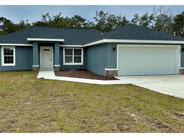 New single-story home with gray exterior, two-car garage, and landscaped lawn at 201 Locust Rd, Ocala, FL 34472