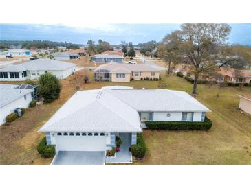 Charming single Gathering home with attached garage and a well-maintained lawn in a quiet neighborhood at 9866 Sw 59Th Cir, Ocala, FL 34476