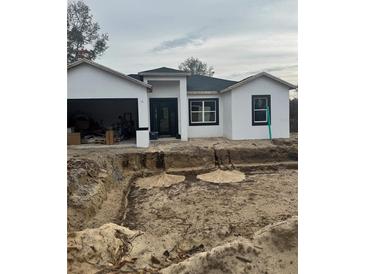 Newly constructed home with a modern design and attached garage at 35 Locust Terrace Way, Ocala, FL 34472