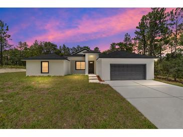 Single story house, gray garage, sunset view at 4444 Sw 118 Ter, Ocala, FL 34481