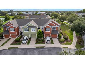 Beautiful townhome exteriors showcase attached garages, vibrant landscaping, and colorful facades at 4230 Sw 50Th Cir, Ocala, FL 34474