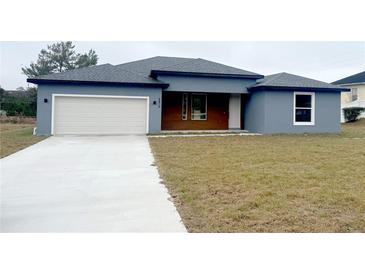 Charming single-story home featuring a two-car garage and modern architectural details at 4872 Sw 100Th St, Ocala, FL 34476