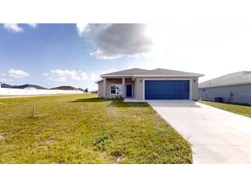 New single-story house with blue garage door and grassy yard at 5348 Se 91St Pl, Ocala, FL 34480