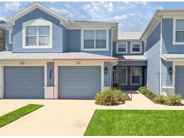Charming townhome showcasing a well-maintained exterior with a garage and landscaping at 4560 Sw 52Nd Cir # 101, Ocala, FL 34474
