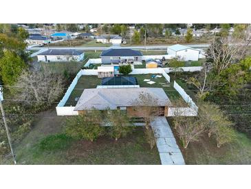 Aerial view of house, fenced backyard, pool, shed, and neighborhood at 147 Juniper Run, Ocala, FL 34480