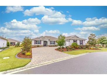 Attractive single-story home with paver driveway and landscaped yard at 9124 Sw 84Th Ln, Ocala, FL 34481