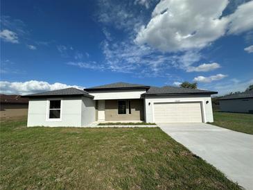 Charming one-story home with a well-maintained lawn and a two-car garage and long concrete driveway at 10107 Sw 41St Ave, Ocala, FL 34476