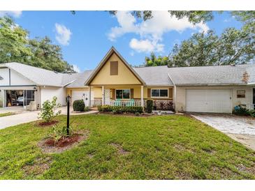 Lovely single-story home with a quaint porch, featuring lush landscaping and an A-frame roof at 9357 Sw 82Nd Ter # B, Ocala, FL 34481