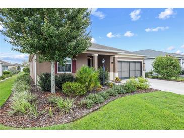 Charming single story home with manicured lawn and colorful, mature landscaping at 7709 Sw 86Th Ct, Ocala, FL 34481