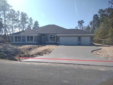 Beautiful single-story home boasts an attached two-car garage, a modern roof, and a well-manicured front yard at 4378 Sw 113Th Pl, Ocala, FL 34476