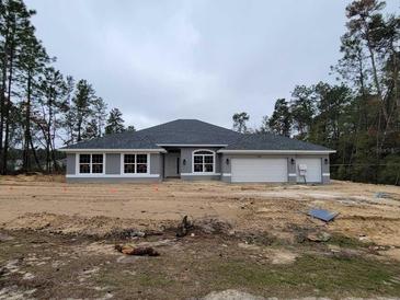 New single-story home with gray siding, attached garage, and landscaping at 4378 Sw 113Th Pl, Ocala, FL 34476