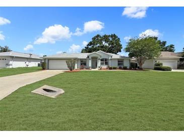 Charming single-story home featuring a well-manicured lawn and a classic architectural design at 4937 Nw 30Th Pl, Ocala, FL 34482