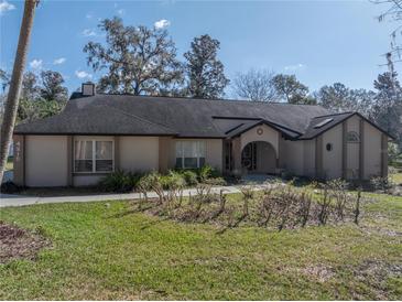 Charming single-story home featuring a well-manicured lawn, inviting entryway, and attractive landscaping at 4215 Se 24Th Ter, Ocala, FL 34480