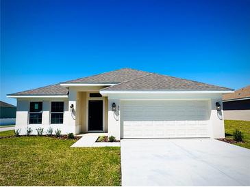 Charming single-story home with a well-manicured lawn and attached two-car garage, perfect for suburban living at 3106 Ne 46Th Ave, Ocala, FL 34470