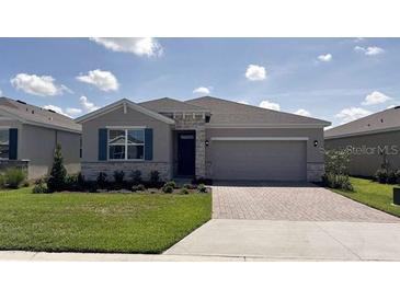 Charming single-story home with a two car garage, stone accents, and well-manicured front lawn at 4111 Nw 48Th Terrace Rd, Ocala, FL 34482