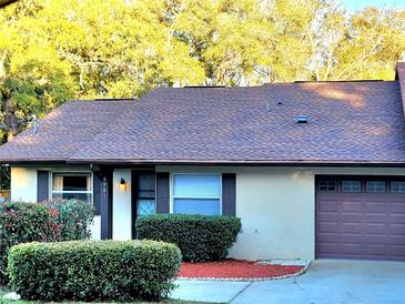 Charming one-story home featuring a well-maintained lawn, front bushes, and a single-car garage at 4961 Sw 196Th Ave, Dunnellon, FL 34431