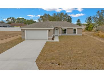 Single-story house with a garage and a spacious lawn at 45 Water Trak, Ocala, FL 34472