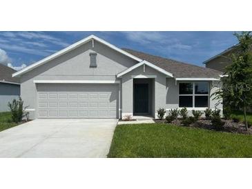 Charming single-story home with a two-car garage and manicured lawn at 8457 Las Palmas Way, Wildwood, FL 34785