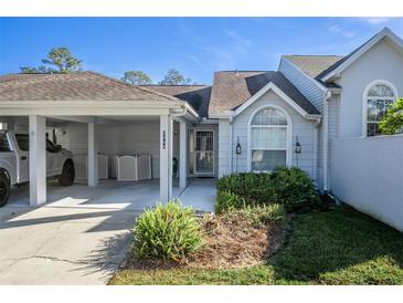 Inviting exterior of condo with carport and landscaping at 2444 Se 18Th Cir, Ocala, FL 34471