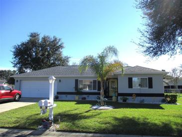 Charming single-story home with lush lawn, landscaped yard, and inviting curb appeal on a sunny day at 11354 Sw 138Th Pl, Dunnellon, FL 34432