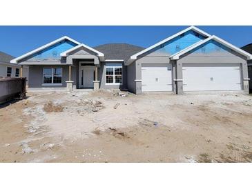 Charming single-story home with a two-car garage and neutral gray paint at 8309 Sw 58Th Ave, Ocala, FL 34476