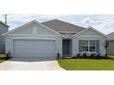 Charming single-story home featuring a two-car garage, manicured lawn, and welcoming entrance at 8838 Sw 48Th Ave, Ocala, FL 34476