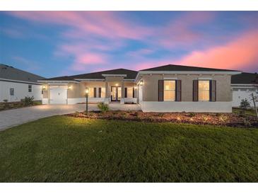 Beautiful home with a landscaped lawn and paver driveway at 9769 Sw 79Th Lane Rd, Ocala, FL 34481