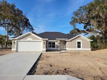 New construction home featuring a two-car garage and neutral exterior at 7605 Sw 103Rd Loop, Ocala, FL 34476