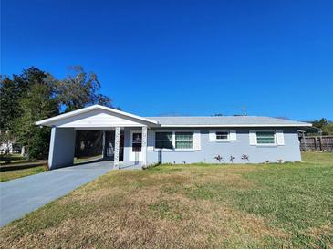 Cute ranch home with carport and well-maintained lawn at 711 Ne 43Rd St, Ocala, FL 34479