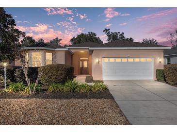 Attractive single-story home with a two-car garage and well-manicured landscaping at 7947 Sw 80Th Place Rd, Ocala, FL 34476