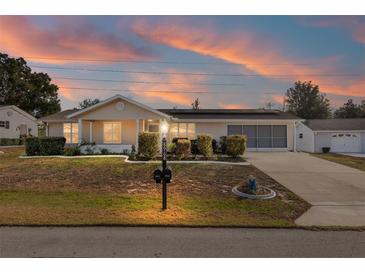 Ranch style home with solar panels and landscaped yard at 8968 Sw 116Th Place Rd, Ocala, FL 34481