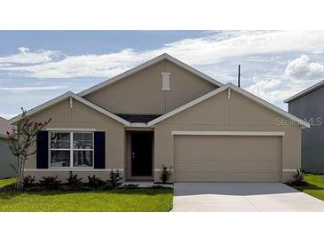 Charming single-story home featuring a two-car garage, well-manicured lawn, and beautiful landscaping at 8878 Sw 48Th Ave, Ocala, FL 34476